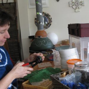 Cutting tesserae for the tulips on the column of "By the pool"